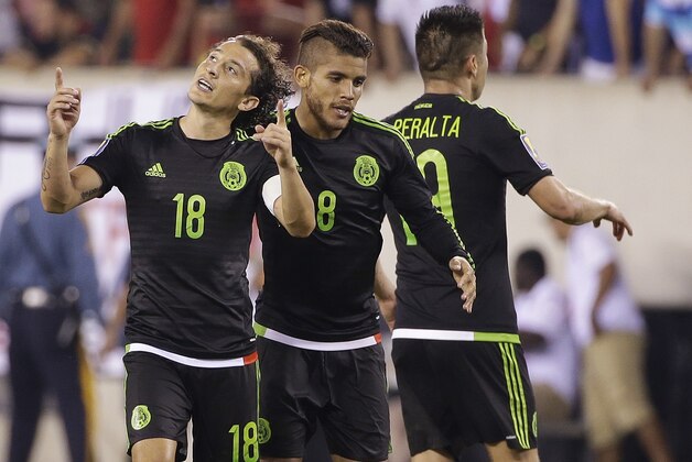 Mexico's Andres Guardado (18) and Jonathan Dos Santos (8) celebrate during the overtime period of a CONCACAF Gold Cup soccer match against Costa Rica Sunday, July 19, 2015, at MetLife stadium in East Rutherford, N.J. Mexico won 1-0. (AP Photo/Seth Wenig)