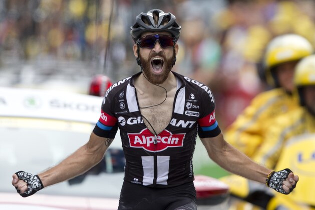 Germany's Simon Geschke celebrates as he crosses the finish line to win the seventeenth stage of the Tour de France cycling race over 161 kilometers (100 miles) with start in Digne-les-Bains and finish in Pra Loup, France, Wednesday, July 22, 2015. (AP Photo/Peter Dejong)