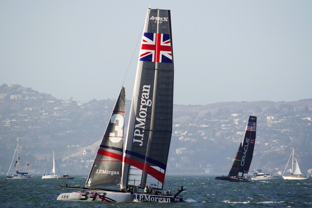 J.P. Morgan Ben Ainslie Racing of Great Britain, left, races against Oracle Team USA Coutts, right, in the first of two fleet races at the America's Cup World Series sailing event in San Francisco, Thursday, Oct. 4, 2012. Racing of the AC45 boats continues though Sunday on San Francisco Bay. J.P. Morgan Ben Ainslie Racing won the first fleet race. (AP Photo/Eric Risberg)