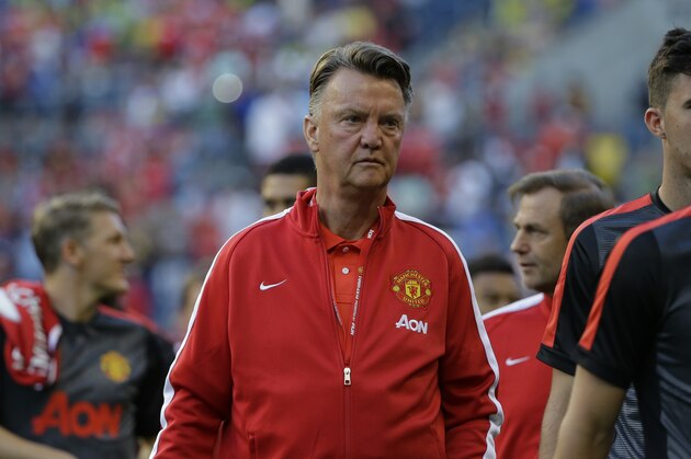 Manchester United manager Louis van Gaal, center, walks with his players onto the pitch at CenturyLink Field before an international friendly soccer match against Club America, Friday, July 17, 2015, in Seattle. (AP Photo/Ted S. Warren)