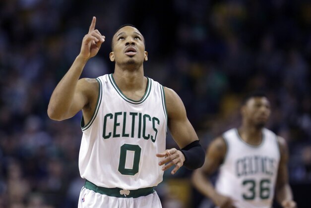 Boston Celtics guard Avery Bradley (0) points upward after scoring against the Miami Heat in the first half of an NBA basketball game in Boston, Wednesday, March 25, 2015. Celtics guard Marcus Smart (36) is in background. (AP Photo/Elise Amendola)