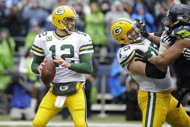 Green Bay Packers quarterback Aaron Rodgers (12) looks to throw against the Seattle Seahawks during the first half of the NFL football NFC Championship game Sunday, Jan. 18, 2015, in Seattle. (AP Photo/Ted S. Warren)