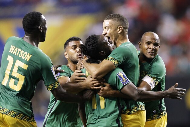 Jamaica’s Darren Mattocks, center, is embraced by teammate Michael Hector, right, after Mattocks scored a goal during the first half of a CONCACAF Gold Cup soccer semifinal against the United States on Wednesday, July 22, 2015, in Atlanta. (AP Photo/David Goldman) Jamaica’s Darren Mattocks, center, is embraced by teammate Michael Hector, right, after Mattocks scored a goal during the first half of a CONCACAF Gold Cup soccer semifinal against the United States on Wednesday, July 22, 2015, in Atlanta. (AP Photo/David Goldman)