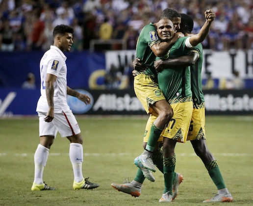 Jamaica’s Rudolph Austin, facing camera, celebrates with teammates Joel McAnuff, left, and Je-Vaughn Watson, right, as United States’ DeAndre Yedlin walks off the pitch after Jamaica defeated the United States 2-1 in a CONCACAF Gold Cup soccer semifinal Wednesday, July 22, 2015, in Atlanta. (AP Photo/David Goldman) Jamaica’s Rudolph Austin, facing camera, celebrates with teammates Joel McAnuff, left, and Je-Vaughn Watson, right, as United States’ DeAndre Yedlin walks off the pitch after Jamaica defeated the United States 2-1 in a CONCACAF Gold Cup soccer semifinal Wednesday, July 22, 2015, in Atlanta. (AP Photo/David Goldman)