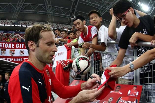 SINGAPORE - JULY 14:  New signing Petr Cech of Arsenal signs autographs for fans during the Arsenal FC open training ahead of the match between Arsenal and Singapore during the 2015 Barclays Asia Trophy Tournament at the Sports Hub National Stadium on July 14, 2015 in Singapore.  (Photo by Stanley Chou/Getty Images)