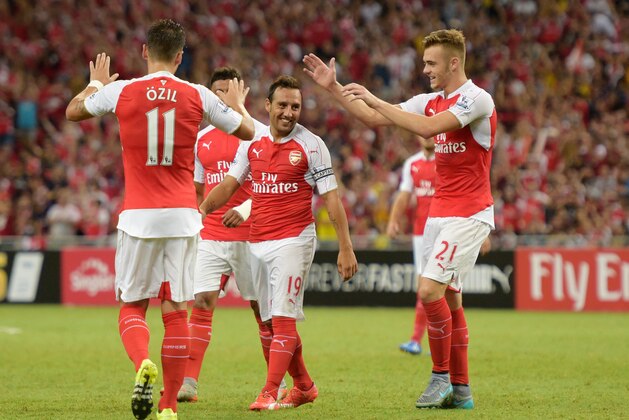 Arsenal's Santi Cazorla, center, celebrates his goal against Everton with teammates during the soccer final match for the Asia Trophy in Singapore, Saturday, July 18, 2015. (AP Photo/Joseph Nair)