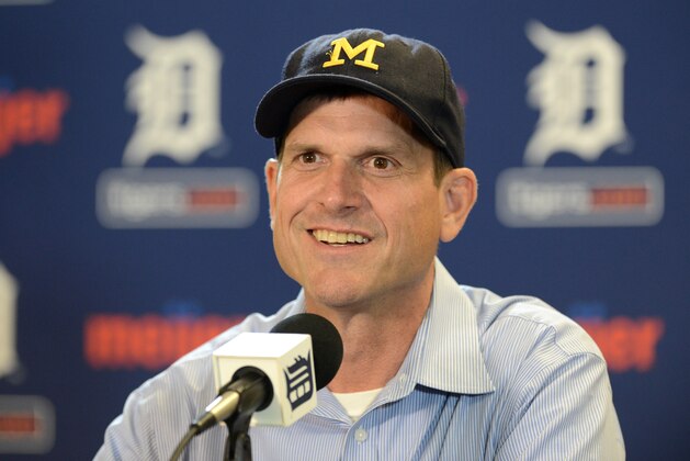 DETROIT, MI - JUNE 30:  University of Michigan head football coach Jim Harbaugh looks on and smiles while talking to the media prior to the Major League Baseball game between the Pittsburgh Pirates and the Detroit Tigers at Comerica Park on June 30, 2015 in Detroit, Michigan.  (Photo by Mark Cunningham/MLB Photos via Getty Images)