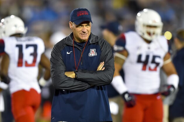 Arizona head coach Rich Rodriguez walks the field before the start of an NCAA college football game against UCLA, Saturday, Nov. 1, 2014, in Pasadena, Calif. (AP Photo/Gus Ruelas)