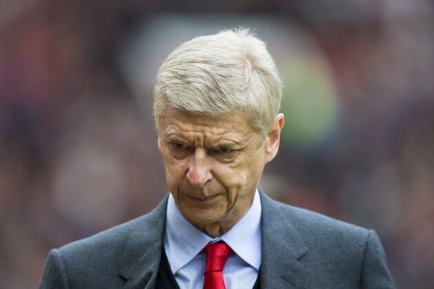 Arsenal's manager Arsene Wenger takes to the touchline before his team's English Premier League soccer match between Manchester United and Arsenal at Old Trafford Stadium, Manchester, England, Sunday, May 17, 2015. (AP Photo/Jon Super)