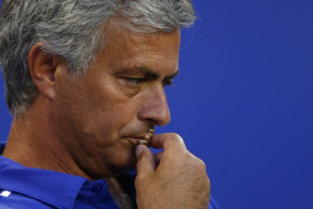 Chelsea FC manager Jose Mourinho kisses a cross before the start of a match against the New York Red Bulls in the International Champions Cup in Harrison N.J., Wednesday, July 22, 2015. Chelsea lost 4-2. (AP Photo/Rich Schultz)