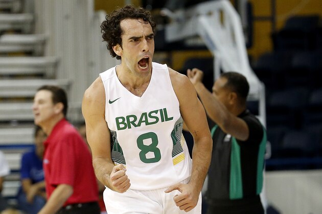 Brazil's Vitor Benite reacts after sinking a 3-point shot during the first quarter of a men's basketball game against Puerto Rico at the Pan Am Games, Tuesday, July 21, 2015, in Toronto. (AP Photo/Julio Cortez)