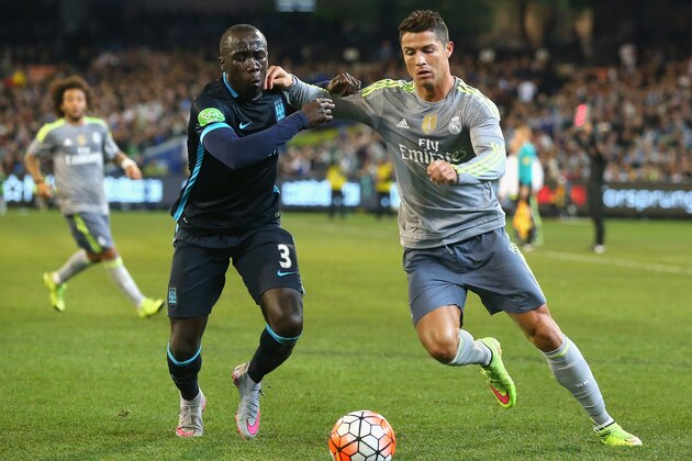 MELBOURNE, AUSTRALIA - JULY 24:  Bacary Sagna of Manchester City and Cristiano Ronaldo of Real Madrid compete for the ball during the International Champions Cup match between Real Madrid and Manchester City at Melbourne Cricket Ground on July 24, 2015 in Melbourne, Australia.  (Photo by Quinn Rooney/Getty Images)
