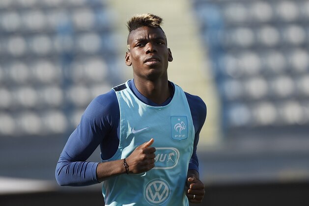 French midfielder Paul Pogba warms up during a training session on June 12, 2015 in Tirana, on the eve of the friendly football match Albania vs France.    AFP PHOTO / LOIC VENANCE        (Photo credit should read LOIC VENANCE/AFP/Getty Images)
