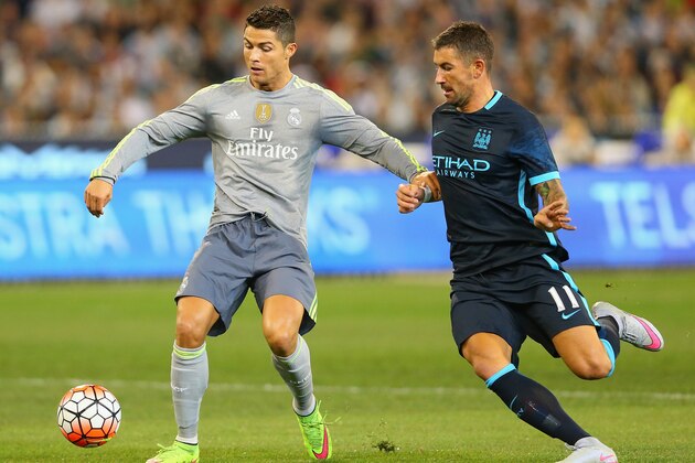 MELBOURNE, AUSTRALIA - JULY 24:  Cristiano Ronaldo of Real Madrid and Aleksandar Kolarov of Manchester City compete for the ball during the International Champions Cup match between Real Madrid and Manchester City at Melbourne Cricket Ground on July 24, 2015 in Melbourne, Australia.  (Photo by Quinn Rooney/Getty Images)