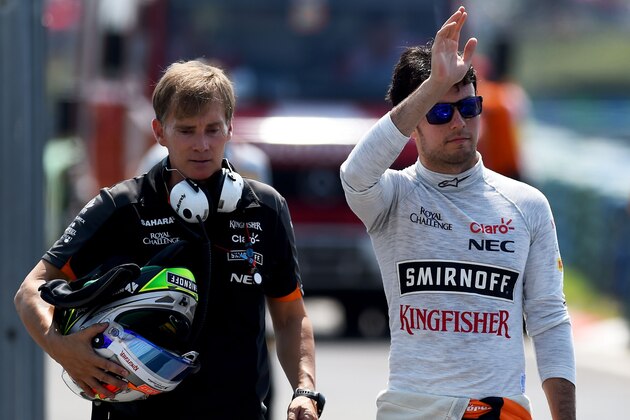 BUDAPEST, HUNGARY - JULY 24:  Sergio Perez of Mexico and Force India returns to the pit lane after crashing during practice for the Formula One Grand Prix of Hungary at Hungaroring on July 24, 2015 in Budapest, Hungary.  (Photo by Lars Baron/Getty Images)