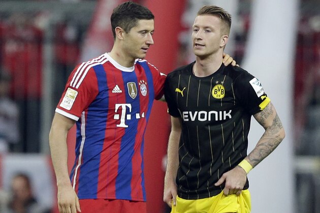 Bayern's Robert Lewandowski from Poland, left, comforts Dortmund's Marco Reus after the German first division Bundesliga soccer match between FC Bayern and Borussia Dortmund in the Allianz Arena in Munich, Germany, on Saturday, Nov. 1, 2014. Bayern Munich won 2-1. (AP Photo/Matthias Schrader)