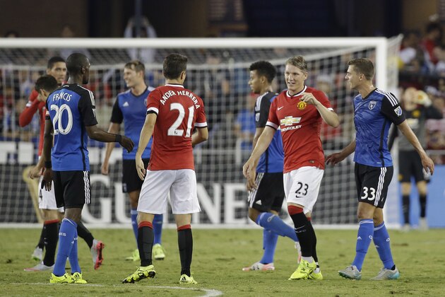 Manchester United midfielder Bastian Schweinsteiger (23) greets teammate Ander Herrera (21) at the end of an International Champions Cup soccer match against the San Jose Earthquakes Tuesday, July 21, 2015, in San Jose, Calif. Manchester United won the match 3-1. (AP Photo/Eric Risberg)