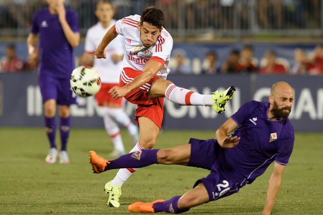Benfica's Pizzi (L) has a shot blocked by Fiorentina's Borja Valero during the International Champions Cup match between SL Benfica and Fiorentina July 24, 2015 in East Hartford, Connecticut. AFP PHOTO/DON EMMERT        (Photo credit should read DON EMMERT/AFP/Getty Images)
