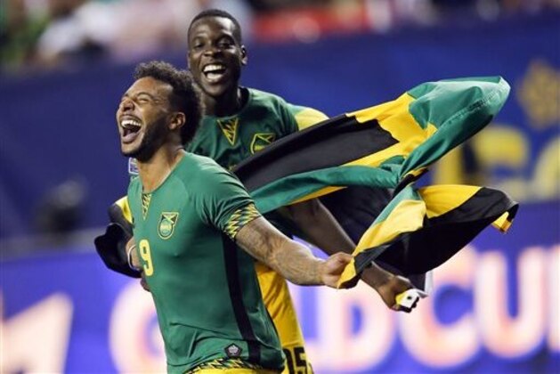 Jamaica’s Giles Barnes (9) and Je-Vaughn Watson celebrate after Jamaica defeated the United States 2-1 in a CONCACAF Gold Cup soccer semifinal, Wednesday, July 22, 2015, in Atlanta.  (AP Photo/John Bazemore)