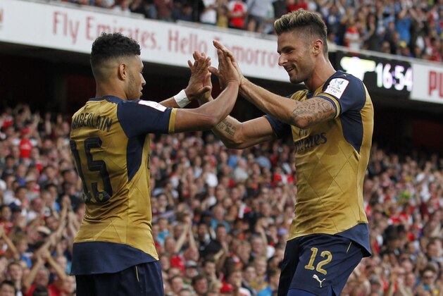 Arsenals English striker Alex Oxlade-Chamberlain (L) celebrates scoring his goal with Arsenals French striker Olivier Giroud during the pre-season friendly football match between Arsenal and Lyon at The Emirates Stadium in north London on July 25, 2015, the game is one of four matches played over two days for the Emirates Cup. AFP PHOTO / IAN KINGTON

RESTRICTED TO EDITORIAL USE. No use with unauthorised audio, video, data, fixture lists, club/league logos or live services. Online in-match use limited to 45 images, no video emulation. No use in betting, games or single club/league/player publications.        (Photo credit should read IAN KINGTON/AFP/Getty Images)
