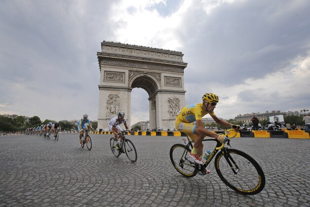 FOR USE AS DESIRED, YEAR END PHOTOS - FILE - Italy's Vincenzo Nibali, wearing the overall leader's yellow jersey, passes the Arc de Triomphe during the twenty-first and last stage of the Tour de France cycling race over 137.5 kilometers (85.4 miles) with start in Evry and finish in Paris, France, Sunday, July 27, 2014. (AP Photo/Christophe Ena, File) FOR USE AS DESIRED, YEAR END PHOTOS - FILE - Italy's Vincenzo Nibali, wearing the overall leader's yellow jersey, passes the Arc de Triomphe during the twenty-first and last stage of the Tour de France cycling race over 137.5 kilometers (85.4 miles) with start in Evry and finish in Paris, France, Sunday, July 27, 2014. (AP Photo/Christophe Ena, File)