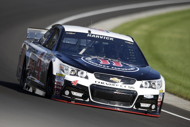 Sprint Cup Series driver Kevin Harvick (4) drives through the first turn during practice for the NASCAR Brickyard 400 auto race at Indianapolis Motor Speedway in Indianapolis, Friday, July 24, 2015. (AP Photo/Michael Conroy)