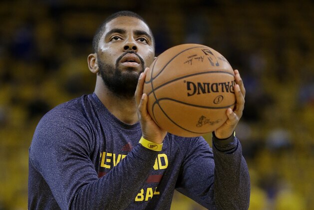 Cleveland Cavaliers guard Kyrie Irving warms up before Game 1 of basketball's NBA Finals against the Golden State Warriors in Oakland, Calif., Thursday, June 4, 2015. (AP Photo/Ben Margot)