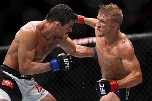 TJ Dillashaw, right, throws a punch to the head of Renan Barao during their bantamweight mixed martial arts title bout during UFC Chicago on Saturday, July 25, 2015, in Chicago. Dillashaw won by TKO in the fourth round. (AP Photo/Jeff Haynes) TJ Dillashaw, right, throws a punch to the head of Renan Barao during their bantamweight mixed martial arts title bout during UFC Chicago on Saturday, July 25, 2015, in Chicago. Dillashaw won by TKO in the fourth round. (AP Photo/Jeff Haynes)