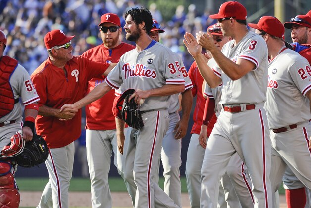 Philadelphia Phillies starting pitcher Cole Hamels, center, is congratulated by teammates after he pitched a no-hitter against the Chicago Cubs, during a baseball game in Chicago on Saturday, July 25, 2015. The Phiillies won 5-0. (AP Photo/Matt Marton)