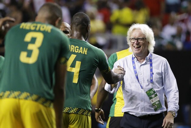 Jamaica  coach Winfried Schaefer, right, celebrates with Wes Morgan after Jamaica defeated the United States 2-1 in a CONCACAF Gold Cup semifinal playoff soccer game Wednesday, July 22, 2015, in Atlanta. (AP Photo/David Goldman)