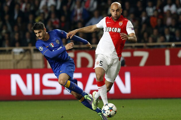 Juventus' Alvaro Morata, left is challenged by Monaco's Aymen Abdennour during the Champions League quarterfinal second leg soccer match between Monaco and Juventus at Louis II stadium in Monaco, Wednesday, April 22, 2015. (AP Photo/Michel Euler)