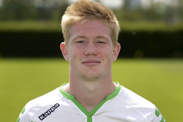 In this photo taken Thursday, July 16, 2015 Wolfsburg’s Kevin De Bruyne from Belgium poses after the official team photo 2015/16 of the German first division, Bundesliga, soccer team in Wolfsburg, Germany. De Bruyne has been named Germany's footballer of the year in an annual poll of sports journalists, as it was announced Sunday, July 26, 2015. (AP Photo/Michael Sohn)