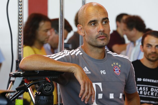 Bayern's head coach Pep Guardiola waits for the start of an official photo shooting for the upcoming German first division Bundesliga soccer season 2015/16 in Munich, Germany, Thursday, July 16, 2015. (AP Photo/Matthias Schrader)