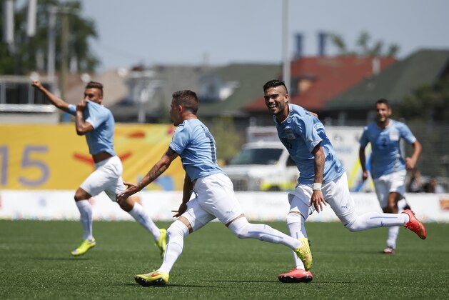 Uruguay’s Brian Lozano, second left, celebrates with teammates after scoring against Mexico during the men's gold medal soccer match at the Pan Am Games in Hamilton, Ontario, Sunday, July 26, 2015. (AP Photo/Felipe Dana)