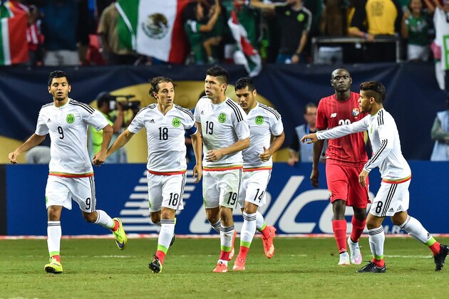 Mexico's Andres Guardado (2nd L)celebrates with Jesus Corona after scoring a penalty against Panama during a CONCACAF Gold Cup semifinal football match in Atlanta on July 22, 2015.    AFP PHOTO/NICHOLAS KAMM        (Photo credit should read NICHOLAS KAMM/AFP/Getty Images)