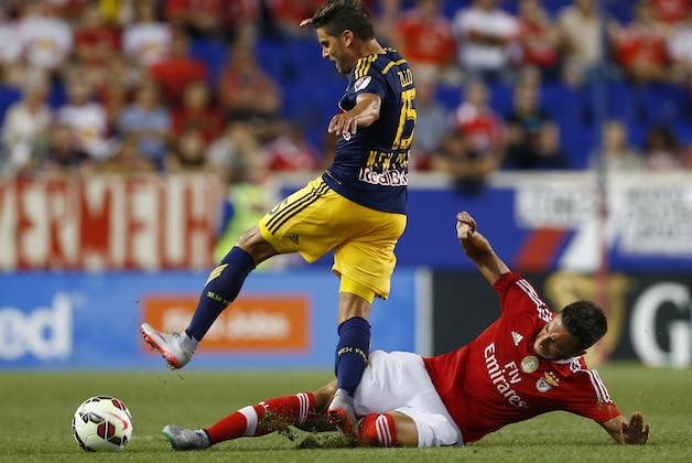 SL Benfica midfielder Andreas Samaris, right, makes a sliding tackle on a ball by New York Red Bulls midfielder Sal Zizzo, left, during the first half of a soccer match in the International Champions Cup in Harrison N.J., Sunday, July 26, 2015. (AP Photo/Rich Schultz)
