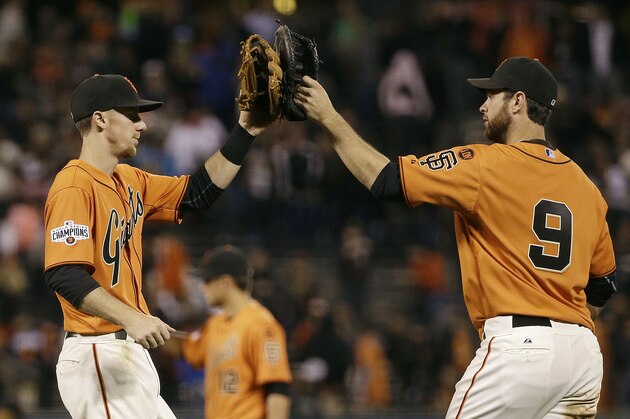 San Francisco Giants third baseman Matt Duffy, left, and first baseman Brandon Belt (9) celebrate after the Giants beat the Philadelphia Phillies in a baseball game in San Francisco, Friday, July 10, 2015. The Giants won 15-2. (AP Photo/Jeff Chiu)