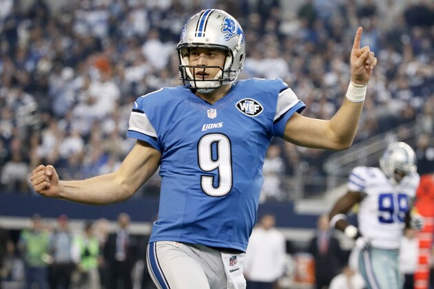 Detroit Lions quarterback Matthew Stafford (9) celebrates after throwing a touchdown pass to wide receiver Golden Tate (15) against the Dallas Cowboys during the first half of an NFL wildcard playoff football game, Sunday, Jan. 4, 2015, in Arlington, Texas. (AP Photo/Tony Gutierrez)