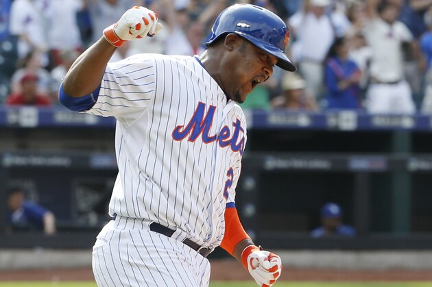 New York Mets Juan Uribe celebrates after hitting a tenth-inning, walk-off single to lift the Mets to a 3-2 victory over the Los Angeles Dodgers in a baseball game in New York, Sunday, July 26, 2015. (AP Photo/Kathy Willens)