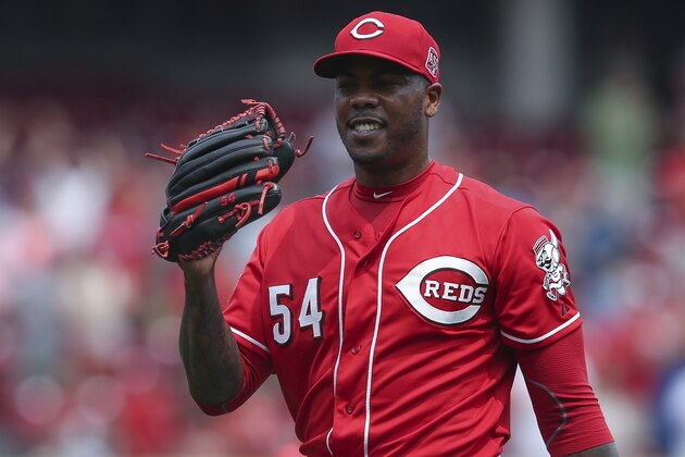 Cincinnati Reds relief pitcher Aroldis Chapman smiles after closing out the ninth inning and recording a save after a baseball game against the Minnesota Twins, Wednesday, July 1, 2015, in Cincinnati. The Reds won 2-1. (AP Photo/John Minchillo)