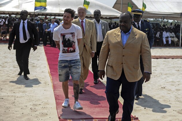Argentinian soccer player and four-time FIFA Ballon d'Or winner Lionel Messi (C) is given a tour during the start of construction of the Port-Gentil Stadium by the President of Gabon, Ali Bongo Ondimba (R) in the Ntchengue district of Port-Gentil on July 18, 2015. Gabon will host the 2017 Africa Cup of Nations soccer tournament. AFP PHOTO / STEVE JORDAN        (Photo credit should read Steve Jordan/AFP/Getty Images)