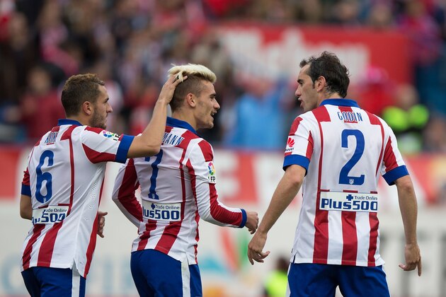 MADRID, SPAIN - APRIL 25: Antoine Griezmann (C) of Atletico de Madrid celebrates scoring their second goal with team mate Koke (L) and Diego Godin (R) during the La Liga match between Club Atletico de Madrid and Elche FC at Vicente Calderon Stadium on April 25, 2015 in Madrid, Spain.  (Photo by Gonzalo Arroyo Moreno/Getty Images)