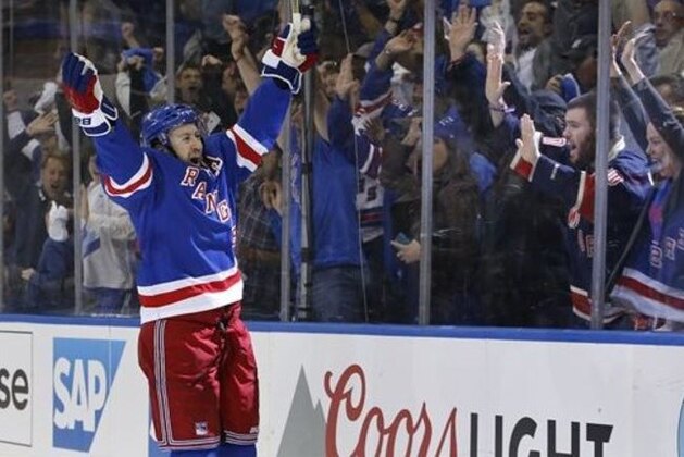 New York Rangers center Derek Stepan (21) celebrates his second period goal against the Tampa Bay Lightning in Game 1 of the Eastern Conference final during the NHL hockey Stanley Cup playoffs, Saturday, May 16, 2015, in New York. (AP Photo/Kathy Willens)