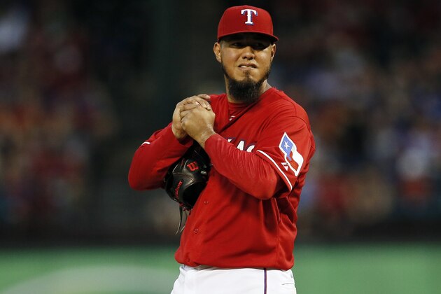Texas Rangers' Yovani Gallardo grips the ball as he stands on the mound after giving up a two-run single to Arizona Diamondbacks' Jake Lamb in the fifth inning of an interleague baseball game Tuesday, July 7, 2015, in Arlington, Texas. (AP Photo/Tony Gutierrez)