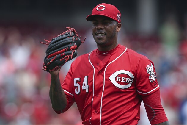 Cincinnati Reds relief pitcher Aroldis Chapman smiles after closing out the ninth inning and recording a save after a baseball game against the Minnesota Twins, Wednesday, July 1, 2015, in Cincinnati. The Reds won 2-1. (AP Photo/John Minchillo)