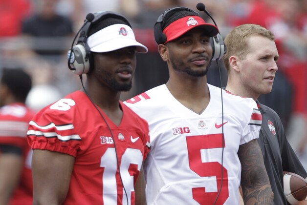 FILE - In this April 18, 2015, file photo, Ohio State quarterbacks Braxton MIller (5) and J.T. Barrett watch during Ohio State's NCAA college football spring game in Columbus, Ohio. Miller is shifting from quarterback to receiver, whittling Ohio State's quarterback competition to two star passers. Miller told SI.com on Thursday night, July 23, that he plans to start the season in the H-back position and also hopes to return punts. He had surgery to repair of torn labrum in his throwing shoulder before the start of last season. (AP Photo/Jay LaPrete, File) FILE - In this April 18, 2015, file photo, Ohio State quarterbacks Braxton MIller (5) and J.T. Barrett watch during Ohio State's NCAA college football spring game in Columbus, Ohio. Miller is shifting from quarterback to receiver, whittling Ohio State's quarterback competition to two star passers. Miller told SI.com on Thursday night, July 23, that he plans to start the season in the H-back position and also hopes to return punts. He had surgery to repair of torn labrum in his throwing shoulder before the start of last season. (AP Photo/Jay LaPrete, File)