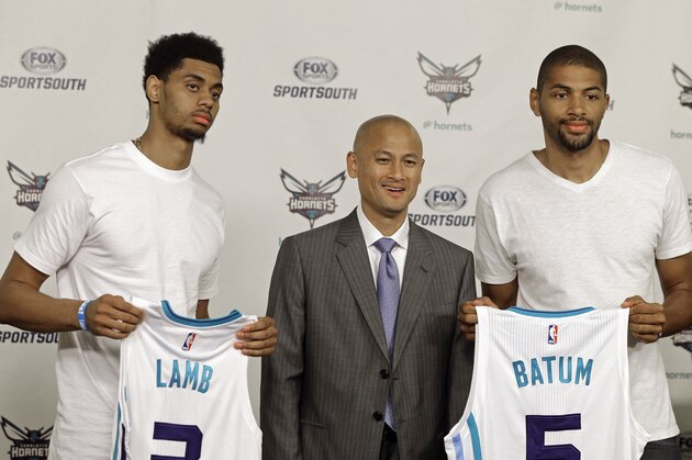 Charlotte Hornets players Nicolas Batum, right, and Jeremy Lamb, left, pose with general manager Rich Cho during a new conference in Charlotte, N.C., Friday, June 26, 2015. The Hornets roster looks vastly different than it did two weeks ago after the team made three trades and drafted Frank Kaminsky in the first round. (AP Photo/Chuck Burton)