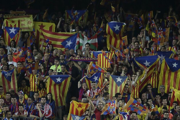 An Athletic fan, center top, sits surrounded by Barcelona fans during the final of the Copa del Rey soccer match between FC Barcelona and Athletic Bilbao at the Camp Nou stadium in Barcelona, Spain, Saturday, May 30, 2015. (AP Photo/Emilio Morenatti)