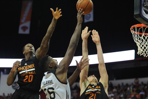 Jul 20, 2015; Las Vegas, NV, USA; San Antonio Spurs center Cady Lalanne (26) shoots between the defense of Phoenix Suns guard Archie Goodwin (20) and center Alex Len (21) during the NBA Summer League Final at Thomas & Mack Center. Mandatory Credit: Stephen R. Sylvanie-USA TODAY Sports