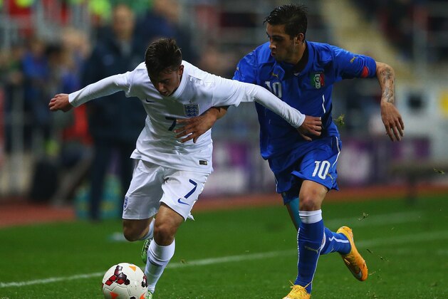ROTHERHAM, ENGLAND - NOVEMBER 14:  Patrick Roberts of England holds off Vittorio Parigini of Italy during the U19 International friendly match between England and Italy at The New York Stadium on November 14, 2014 in Rotherham, England.  (Photo by Matthew Lewis/Getty Images)